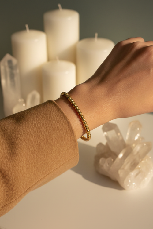 18K gold plated beaded cuff bangle with smooth polished round gold beads worn on a woman's wrist — Bangle Bangle