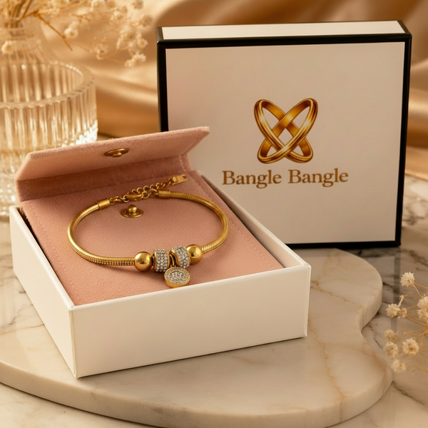 18K gold plated crystal charm snake chain bracelet laid on a pink pouch in a Bangle Bangle gift box — Bangle Bangle
