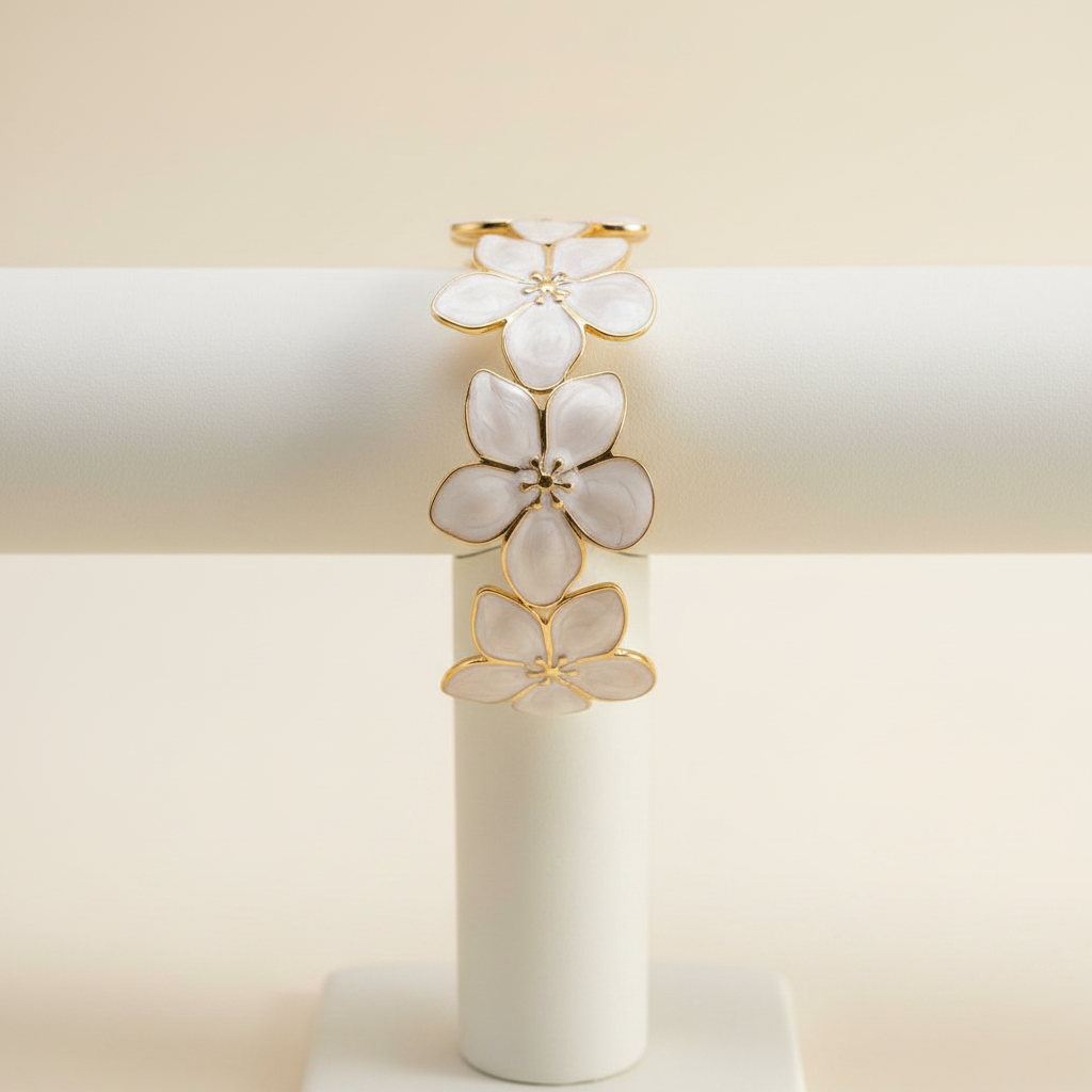 18K gold plated floral blossom cuff bangle with white enamel petals displayed on a jewellery stand — Bangle Bangle