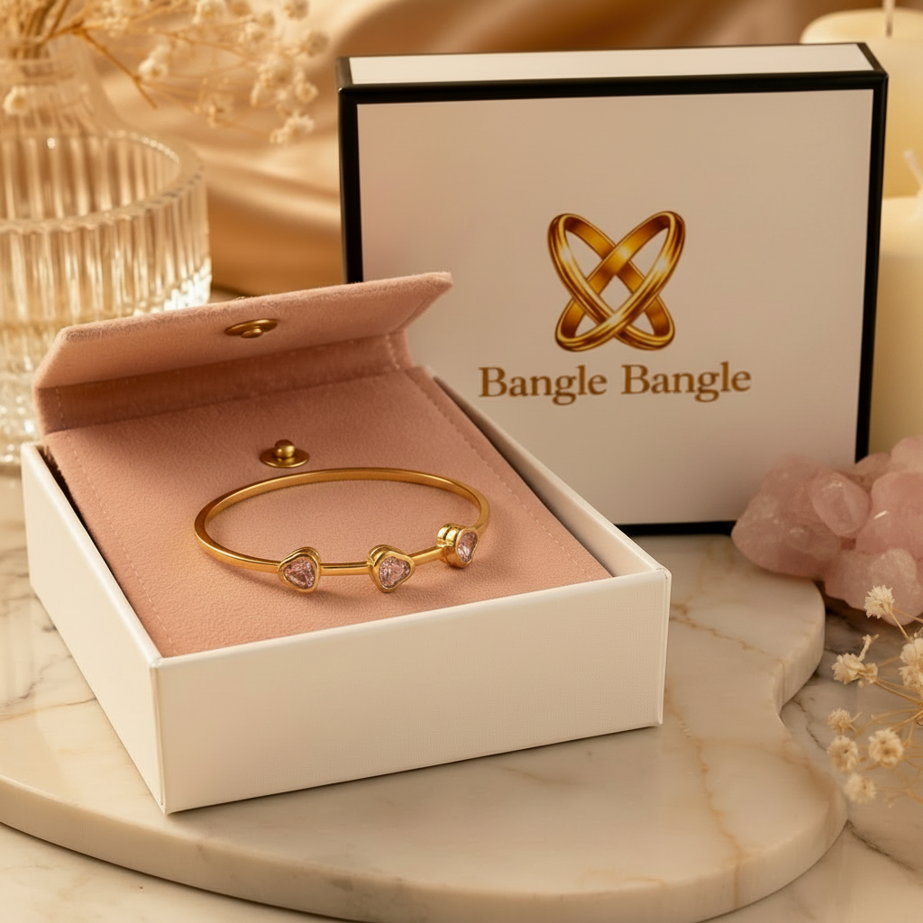 18K gold plated pink crystal heart bangle in open Bangle Bangle white gift box with black trim and pink pouch, styled with candles and rose quartz — Bangle Bangle