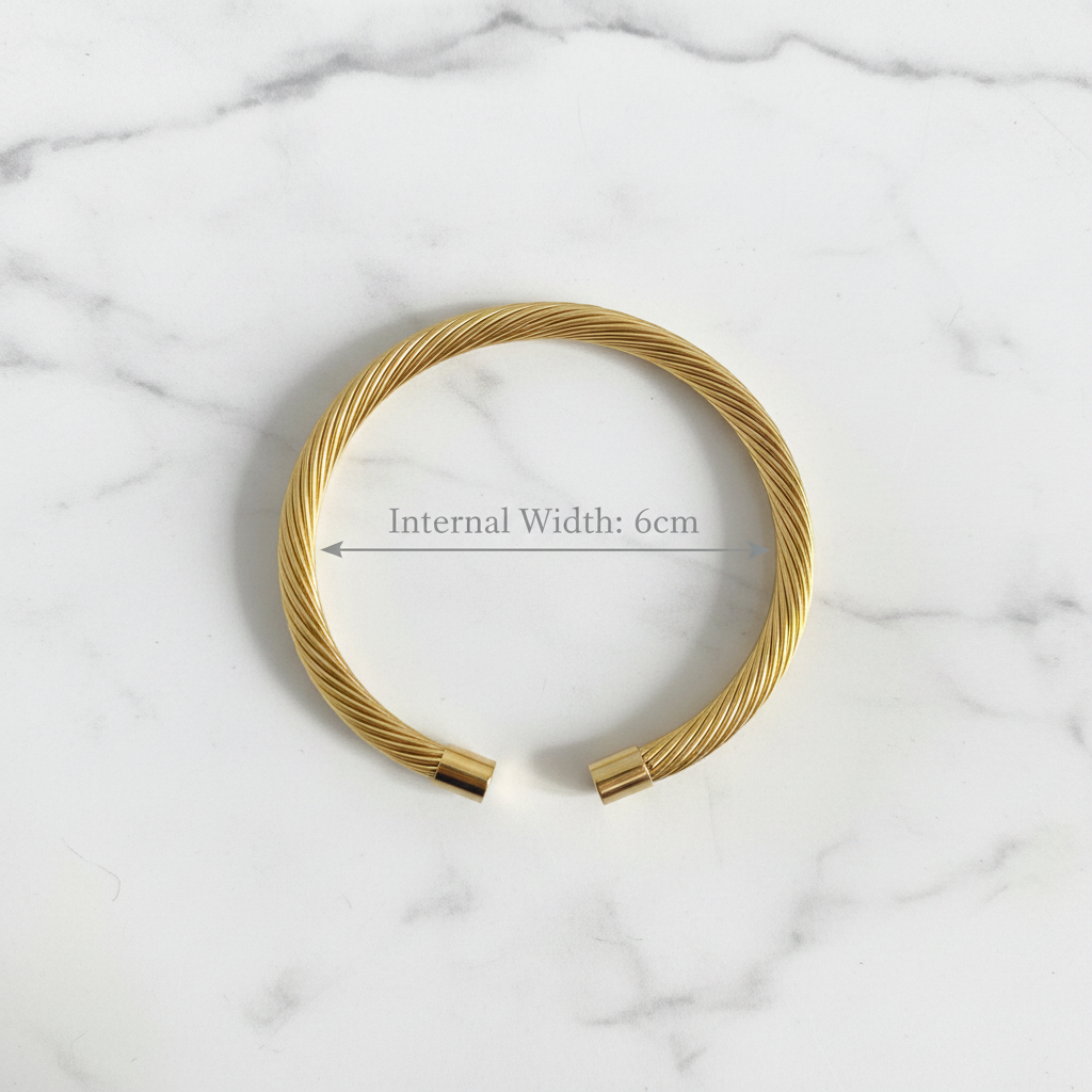 18K gold plated twisted cable open cuff bangle photographed from above sat on white marble showing internal width of 6cm — Bangle Bangle