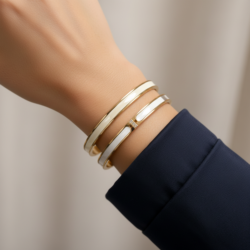18K gold-plated knot cuff bracelet side profile on warm reflective gold surface showing full cuff with polished ball ends